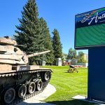 Welcome sign with LED lights and a tank in a park in St. Anthony