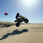 ATV jumping over a sand dune in St. Anthony